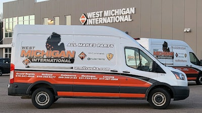 West Michigan International parts van in front of building