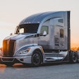 A silver sleeper cab truck with Hiring Our Heroes on the side.