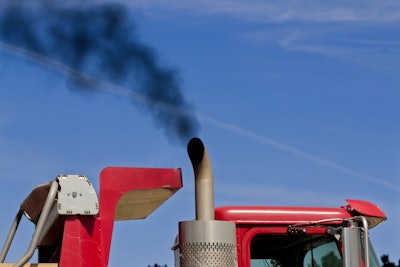 Smoke comes out of the exhaust of a truck.