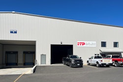 A metal building with a sign that reads, 'ITP Inland Trucks Parts & Service' with three pickups parked in front.