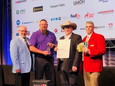 A group of men with an award, certificate and prizes at TMCSuperTech