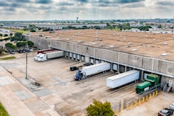 A few trucks parked at a warehouse