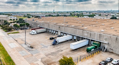 A few trucks parked at a warehouse