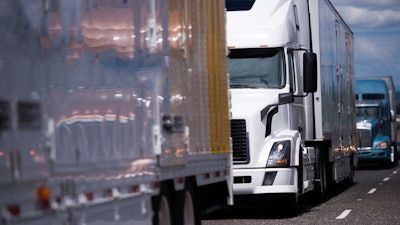 Trucks parked in a line on a highway