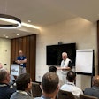 Two men present to a group of NTDA attendees in a hotel conference room.