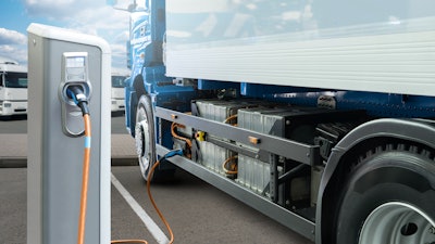 Battery electric truck charging at a power station
