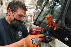Mack assembly line worker working on LR Electric