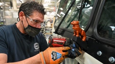 Mack assembly line worker working on LR Electric