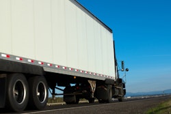 Truck with white trailer on highway