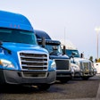 Line of trucks in row starting with blue truck