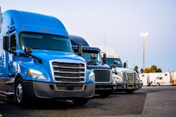 Line of trucks in row starting with blue truck