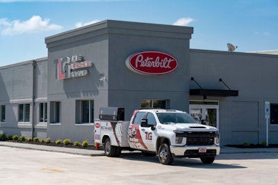 Signage from TLG's rebrand on a building and truck.