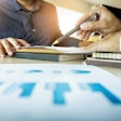 Customer being shown data on a sheet of paper