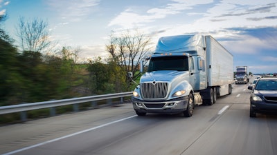 Blue Class 8 tractor on the highway