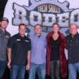 A group of people stand in front of a banner that says Tech Skills Rodeo Est. 2006.