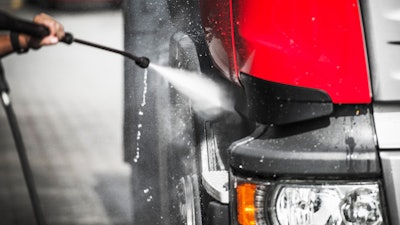 Truck being washed with pressure washer