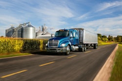 International LT driving in rural area by cornfield