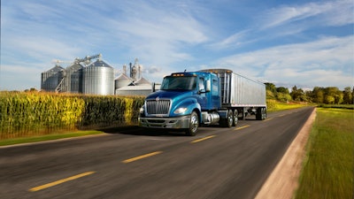 International LT driving in rural area by cornfield