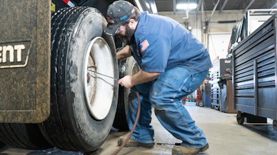 Blaine Brothers technician working on truck