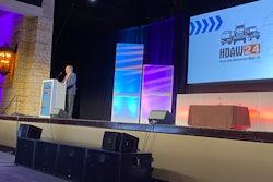 Mike Betts stands behind the podium accepting his elevation to the HD Hall of Fame.