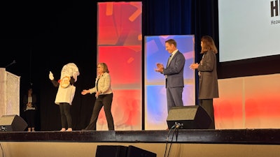 A person in a bill costume takes the HDAW stage with Ann Wilson, Baron Oursler and Lisa Forshee.