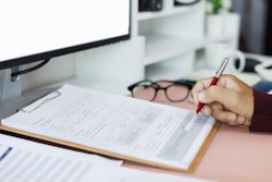 A person works on a tax form.