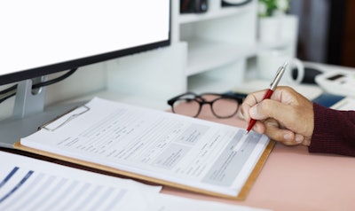 A person works on a tax form.