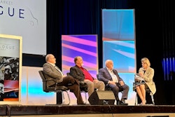 Three men and a woman discuss fleet concerns on a stage.