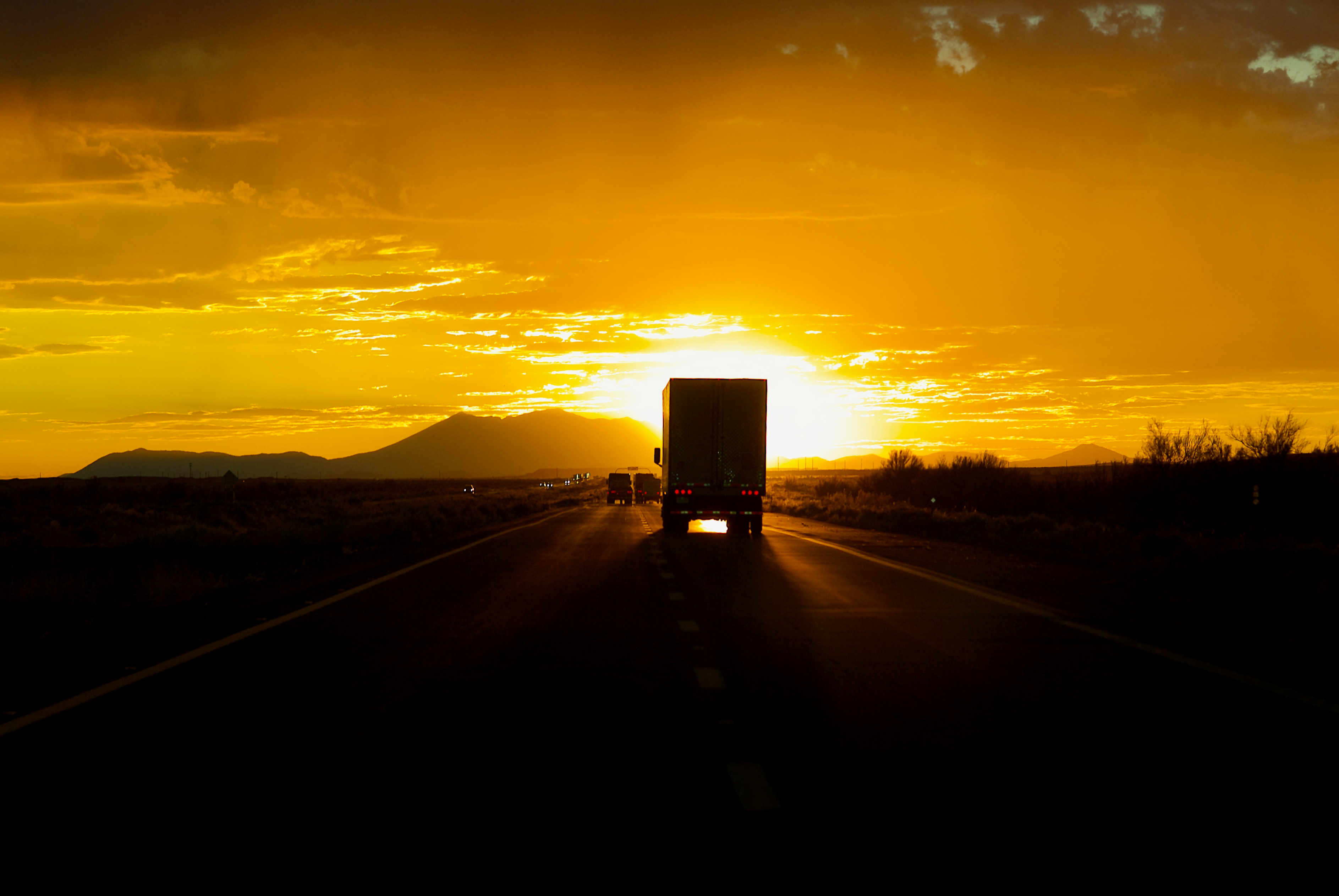 Truck driving into the sun