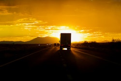 Truck driving into the sun