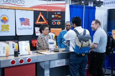 Two women work a booth at HDAW '24.