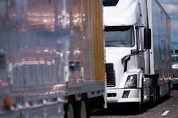 Three trucks in highway traffic