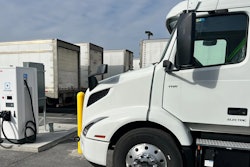 Volvo tractor being charged in a parking lot