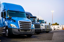 Line of trucks in row starting with blue truck