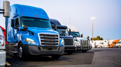 Line of trucks in row starting with blue truck