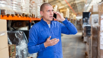 Confused man looking for product in a warehouse