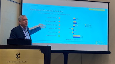 John Blodgett speaking in front of slide at meeting