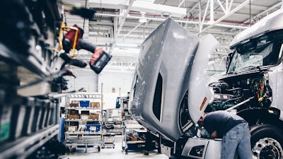 Man working at a truck production facility