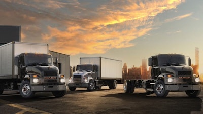 Mack electric truck models in parking lot