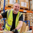 Man laughing working in warehouse