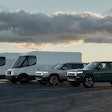 Rivian vehicles lined up against a scenic backdrop