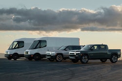 Rivian vehicles lined up against a scenic backdrop