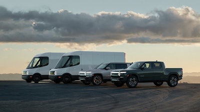 Rivian vehicles lined up against a scenic backdrop
