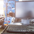 Computer in a service bay with a truck in the background