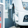 An electric truck next to a charging station.