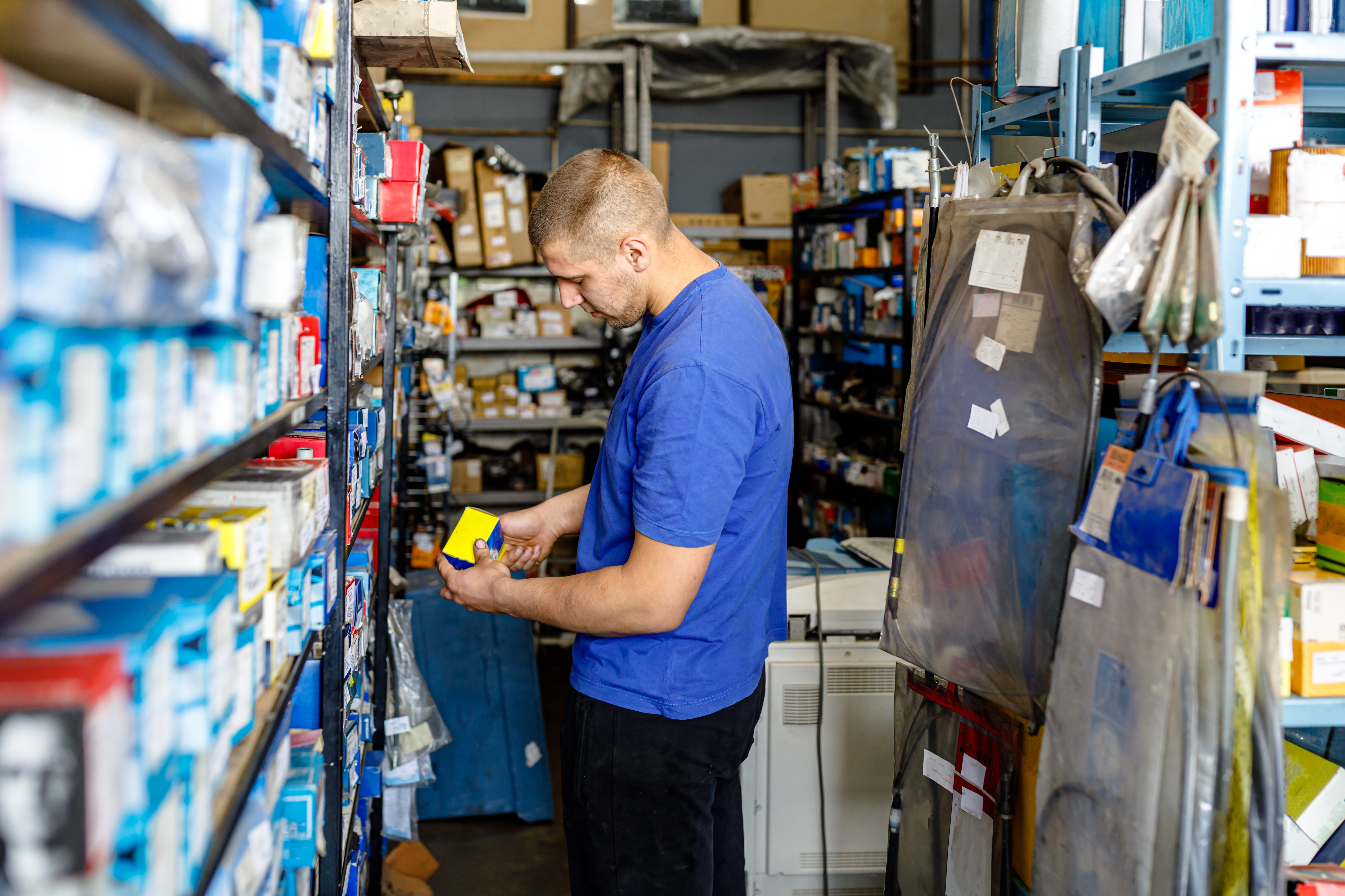 Man in a warehouse looking at part