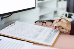 Tax forms and person's hand