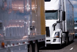 Three trucks in highway traffic