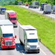 Trucks driving down hill on highway