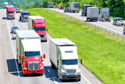 Trucks driving down hill on highway